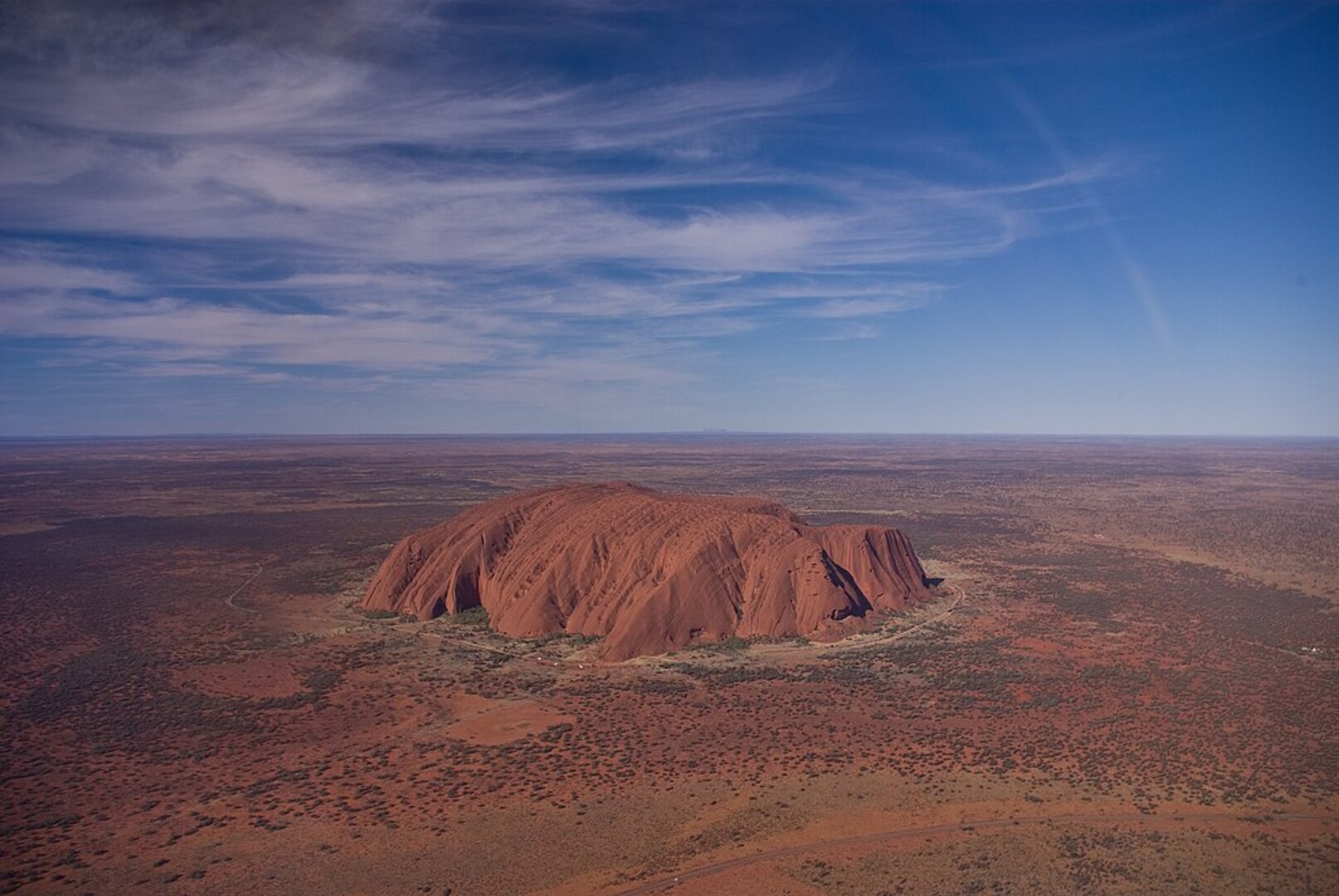 Aerial helicopter view of Uluru and surrounding landscape